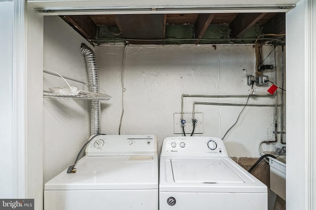 clothes washing area featuring washer and clothes dryer