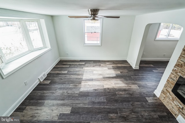 empty room with ceiling fan and dark hardwood / wood-style floors