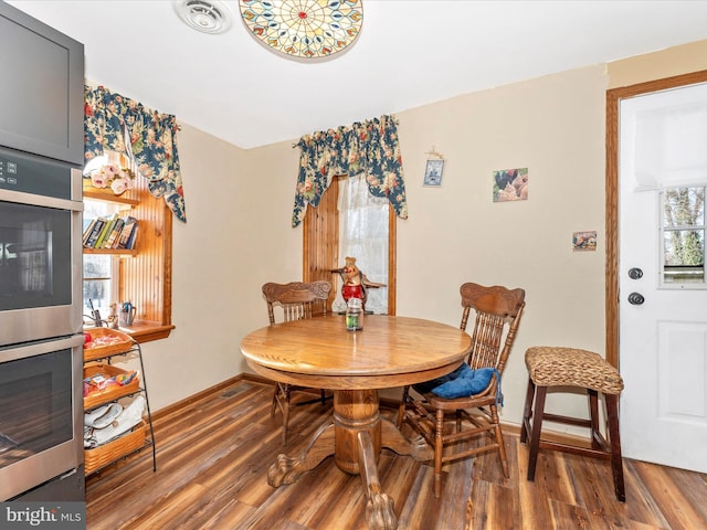 dining space featuring dark hardwood / wood-style flooring