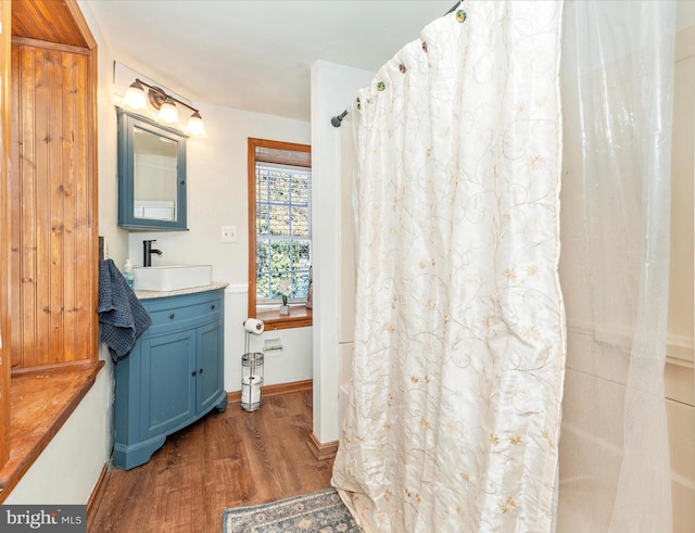 bathroom featuring vanity, hardwood / wood-style flooring, and a shower with curtain