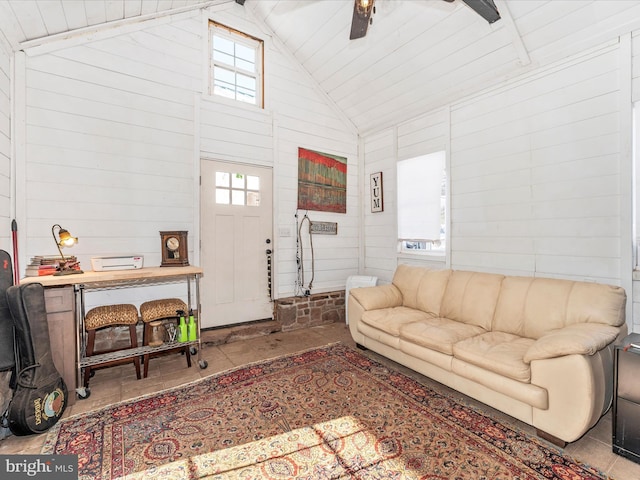 living room featuring plenty of natural light and wooden walls