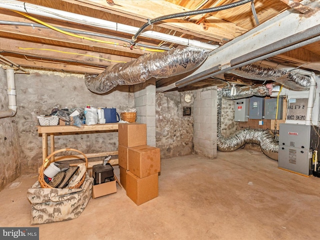 basement featuring heating unit and electric panel