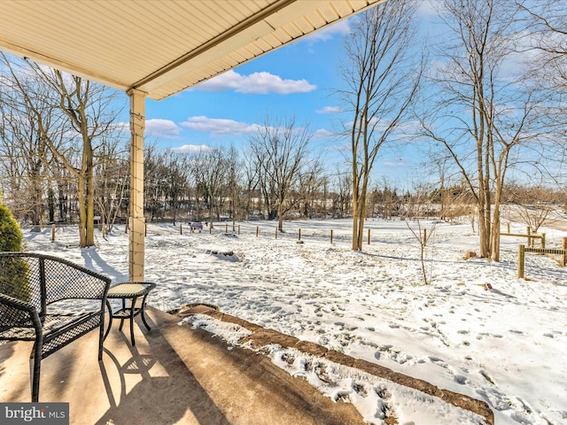 view of yard layered in snow