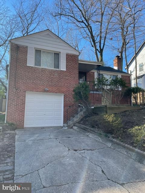 split level home with covered porch and a garage