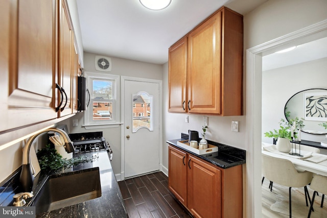 kitchen featuring sink and dark stone counters