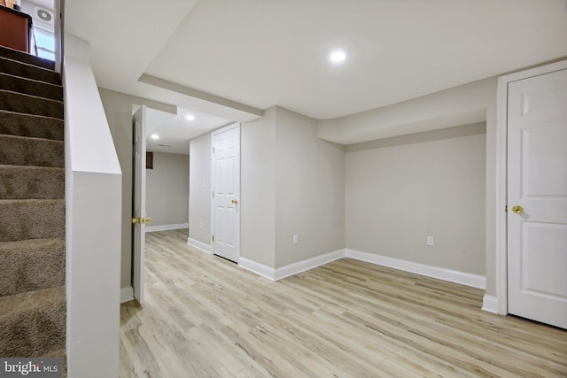 basement with light hardwood / wood-style floors