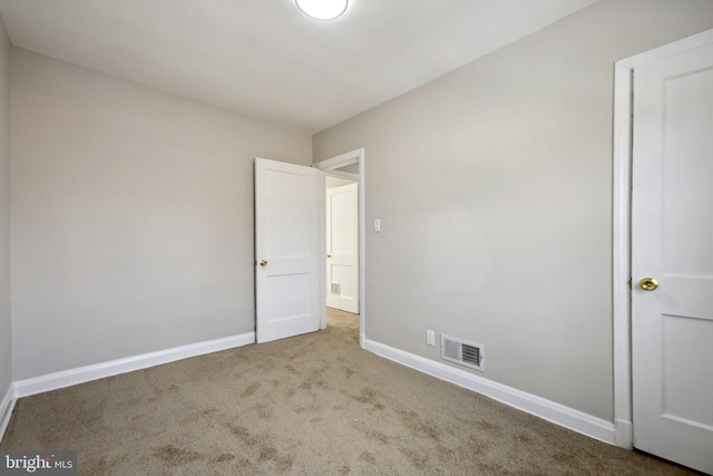 unfurnished room with light carpet