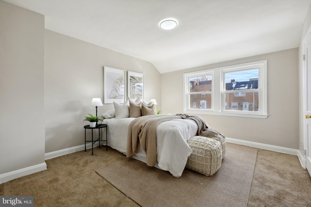 bedroom with lofted ceiling and light carpet