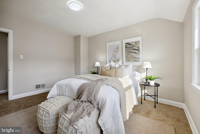 carpeted bedroom featuring lofted ceiling