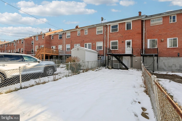 snow covered property featuring central AC unit