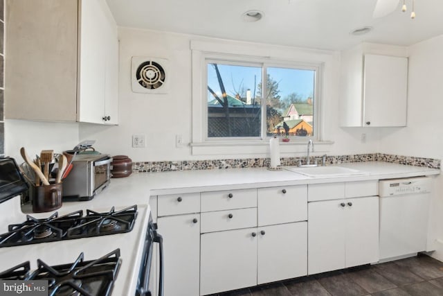 kitchen with range with gas cooktop, white cabinetry, sink, ceiling fan, and white dishwasher