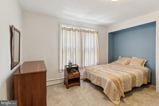 carpeted bedroom with a baseboard heating unit