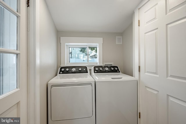 washroom with independent washer and dryer