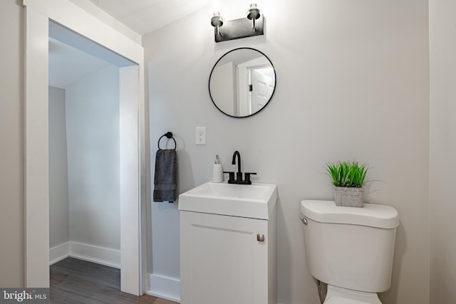 bathroom featuring hardwood / wood-style floors, vanity, and toilet