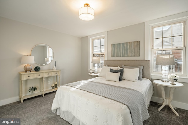 bedroom with dark colored carpet