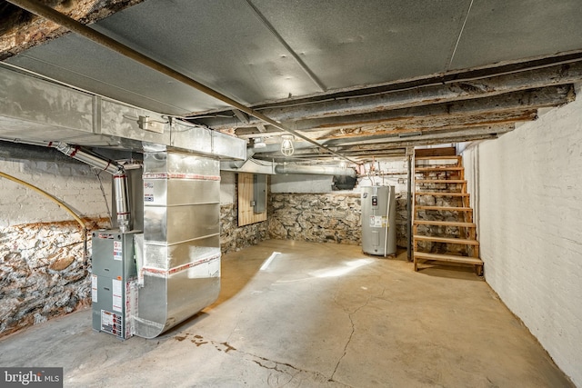 basement featuring heating unit and electric water heater