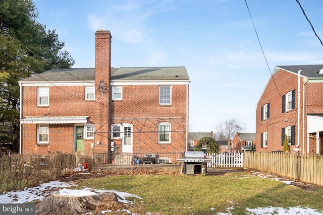 back of house with a lawn