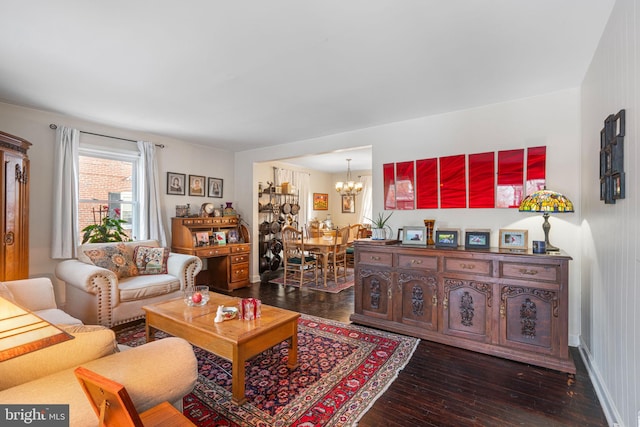 living room featuring dark wood-type flooring and a notable chandelier