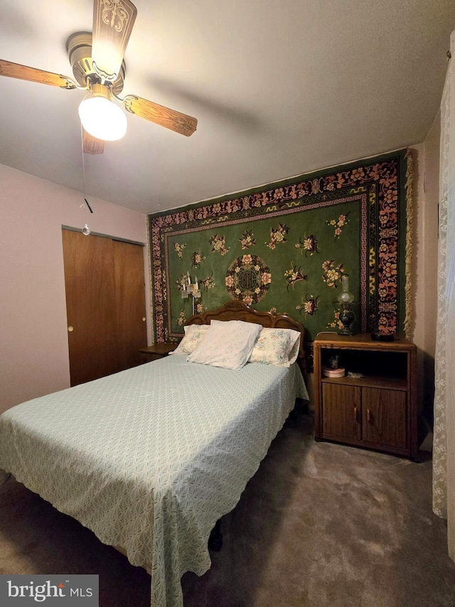 carpeted bedroom with ceiling fan and a closet