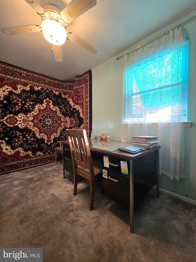 carpeted dining room with ceiling fan