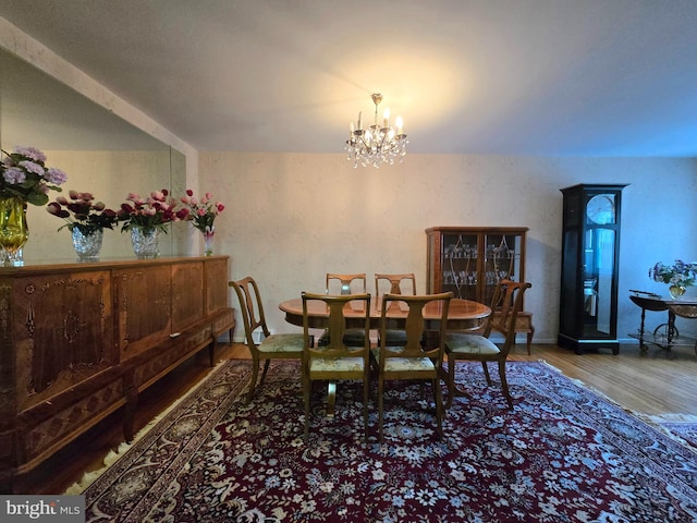 dining area featuring a notable chandelier and hardwood / wood-style floors