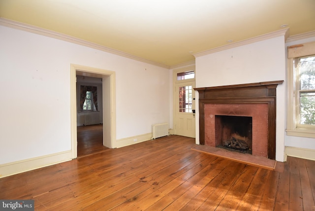 unfurnished living room featuring crown molding, radiator heating unit, and dark wood-type flooring