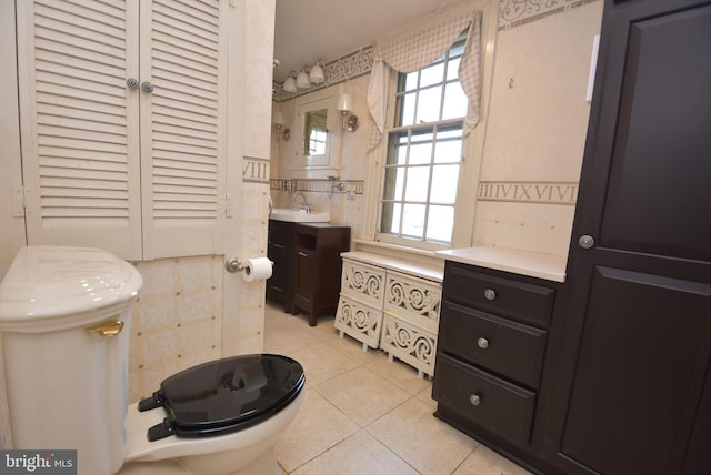 bathroom featuring tile patterned flooring, vanity, and toilet