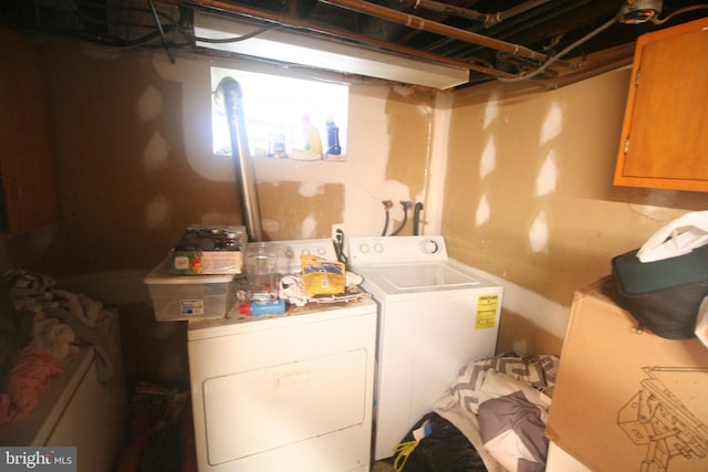 laundry room featuring cabinets and washer and dryer