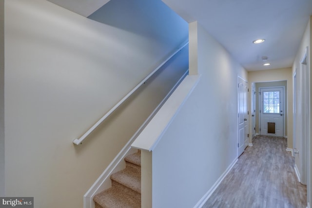 stairs featuring wood-type flooring