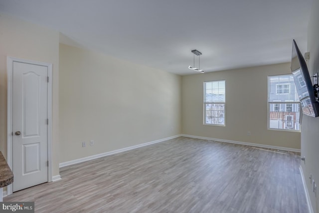 empty room with light hardwood / wood-style floors