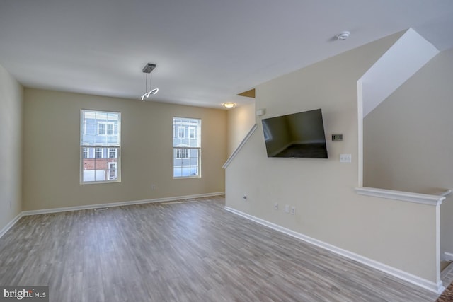 unfurnished living room featuring light hardwood / wood-style flooring