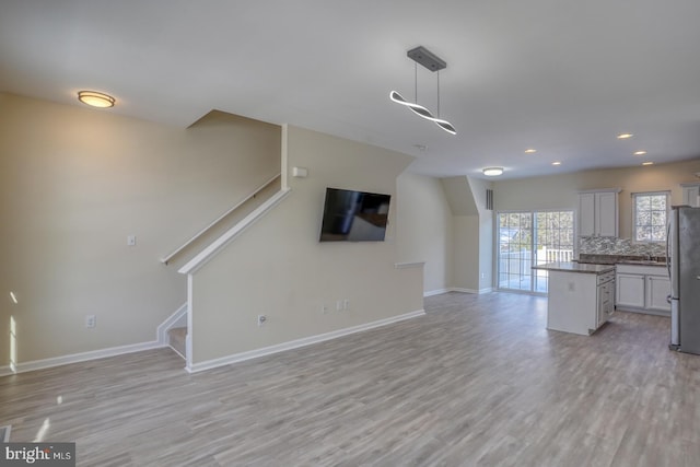 unfurnished living room with light hardwood / wood-style flooring