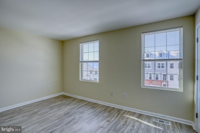 empty room with light hardwood / wood-style flooring