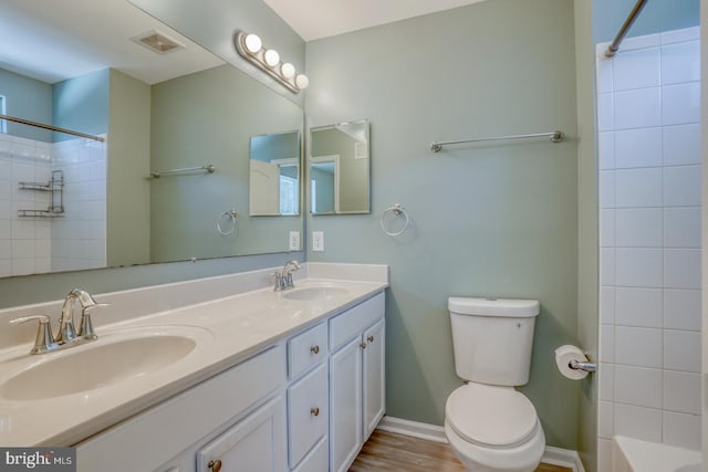 bathroom featuring vanity, toilet, and wood-type flooring