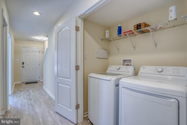 washroom featuring independent washer and dryer and light hardwood / wood-style floors