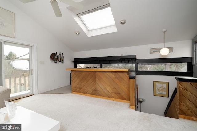 interior space with carpet floors, vaulted ceiling, and ceiling fan