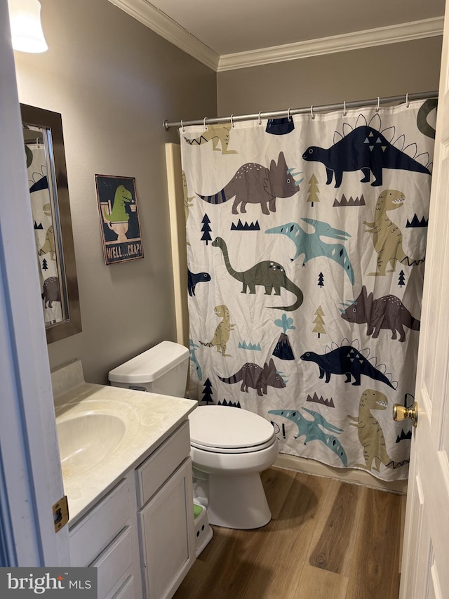 bathroom featuring walk in shower, ornamental molding, vanity, hardwood / wood-style floors, and toilet