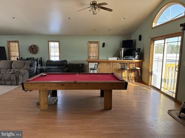 game room featuring indoor bar, light hardwood / wood-style flooring, a healthy amount of sunlight, and billiards