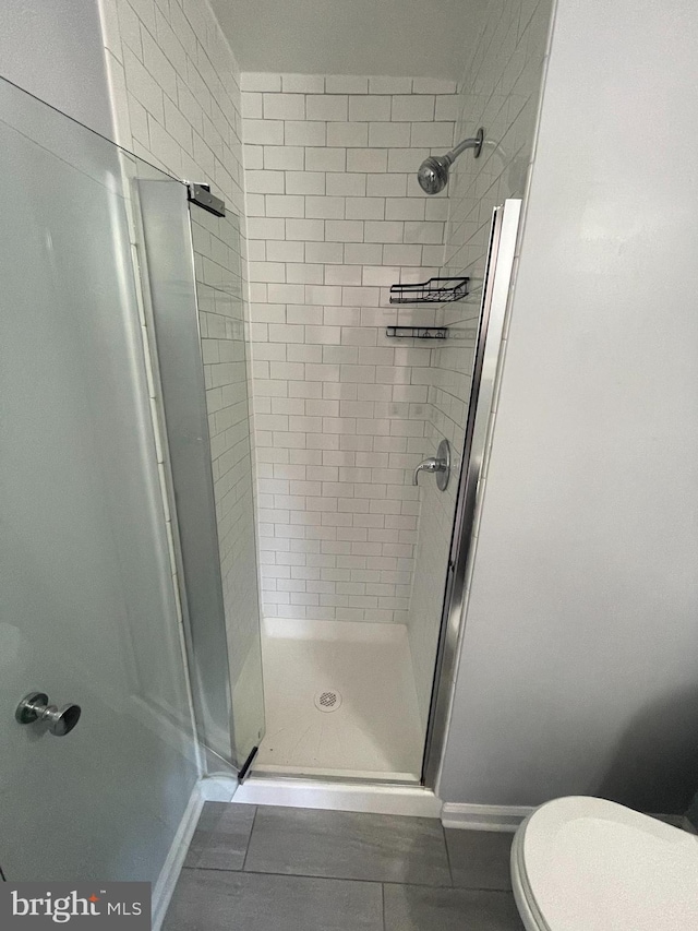 bathroom featuring toilet and walk in shower