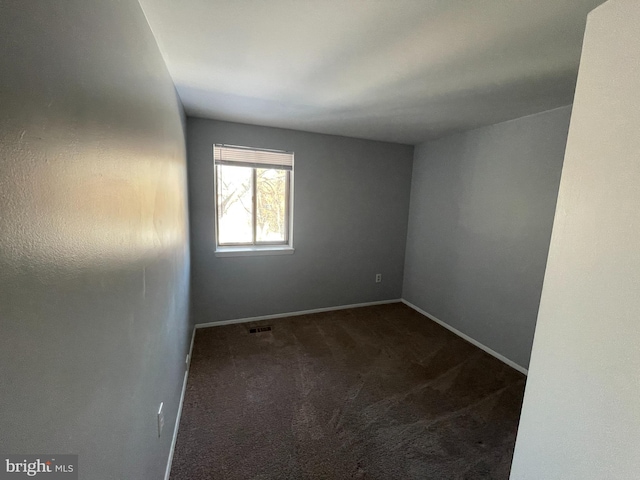 empty room with dark carpet