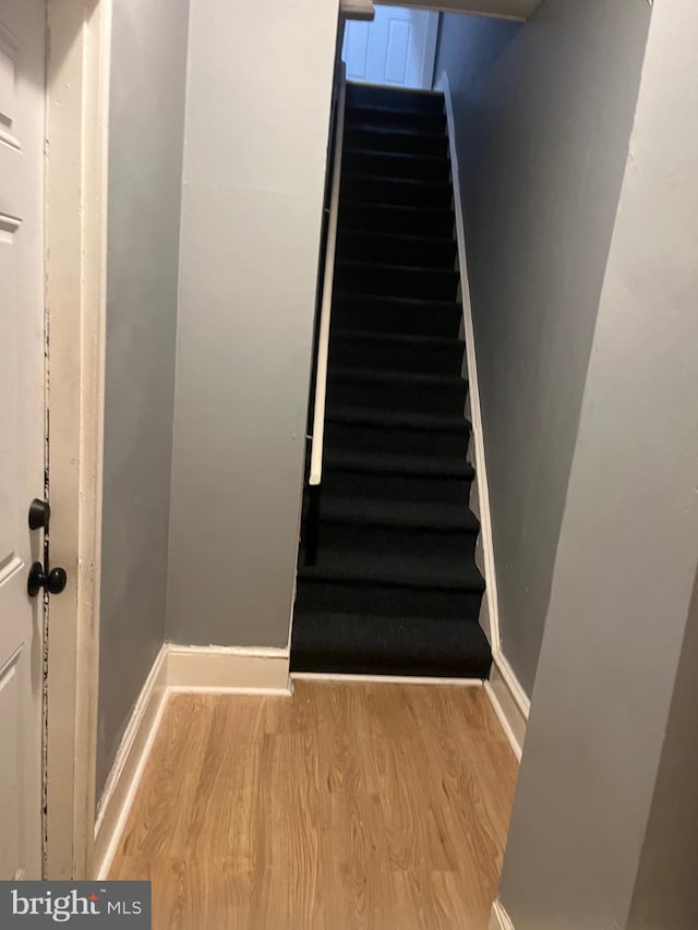 staircase featuring hardwood / wood-style flooring