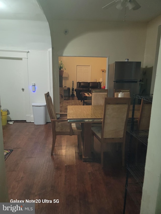 dining room featuring ceiling fan and dark wood-type flooring