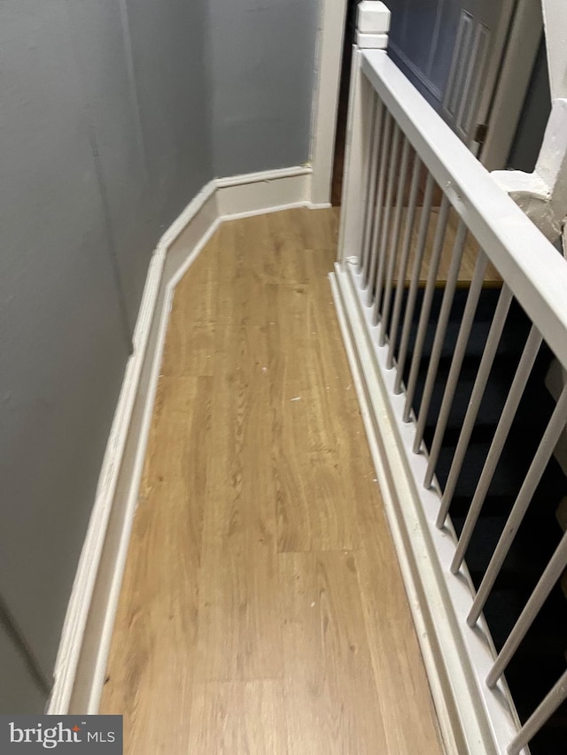 staircase with hardwood / wood-style floors