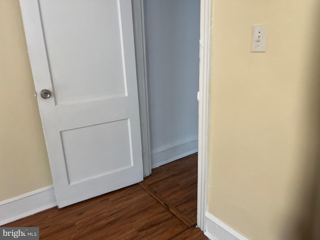 corridor featuring dark hardwood / wood-style floors