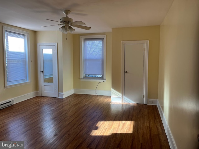 spare room with ceiling fan and dark hardwood / wood-style floors