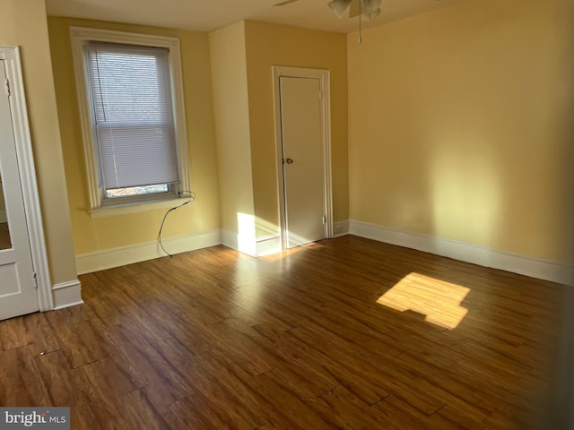 unfurnished bedroom featuring ceiling fan and dark hardwood / wood-style floors