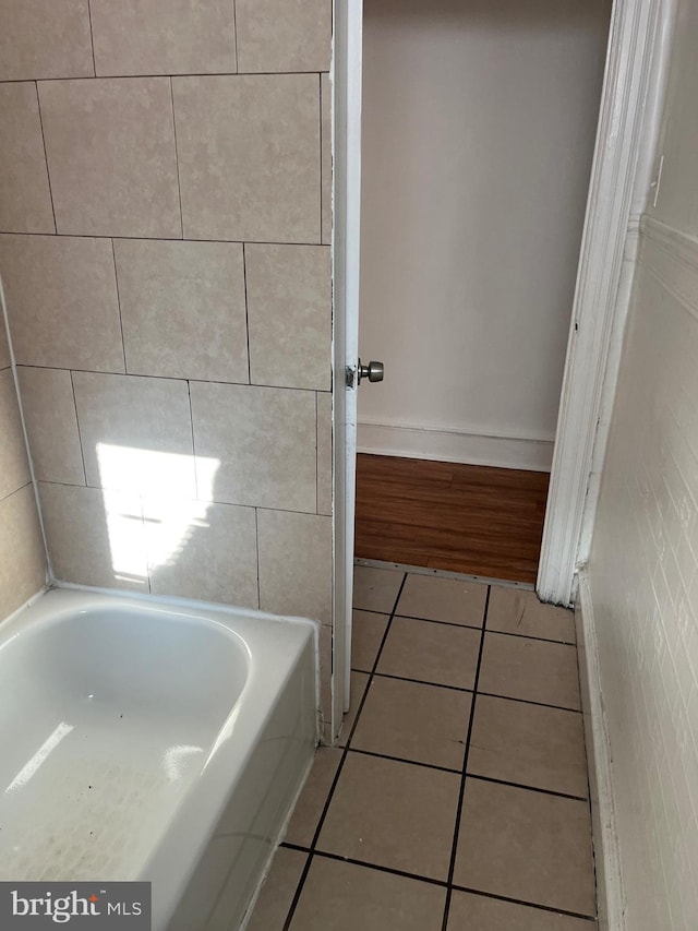 bathroom featuring a washtub and tile patterned flooring