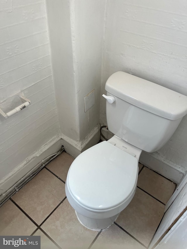 bathroom with toilet and tile patterned flooring