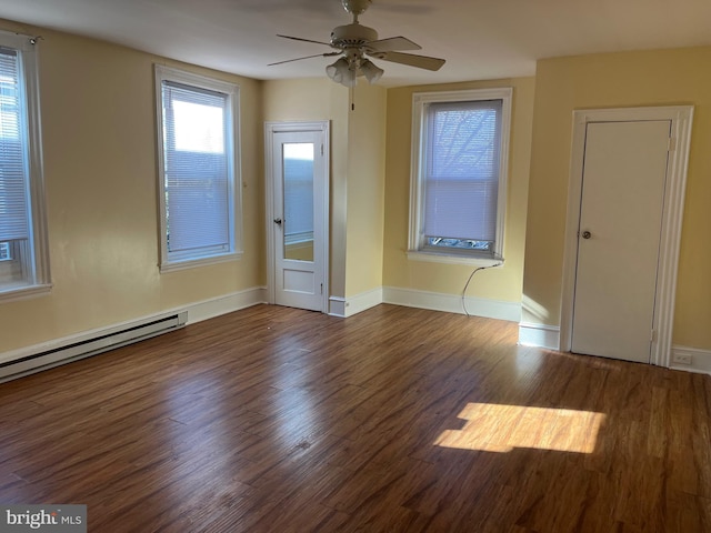 unfurnished room featuring dark wood-type flooring, a baseboard heating unit, and ceiling fan