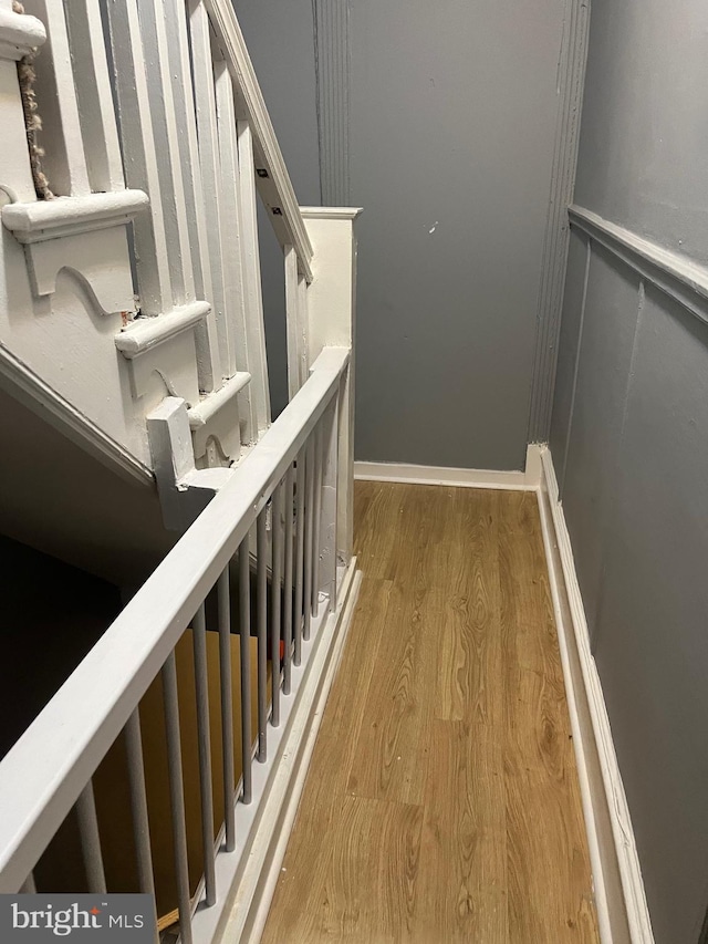 stairway featuring hardwood / wood-style flooring